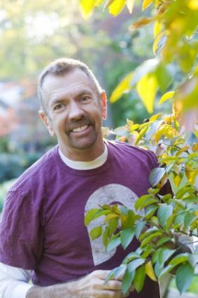 David Culp, garden designer, in a vibrant garden scene with colorful foliage.