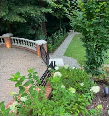 Pathway through lush garden greenery at Charlotte Garden Club.