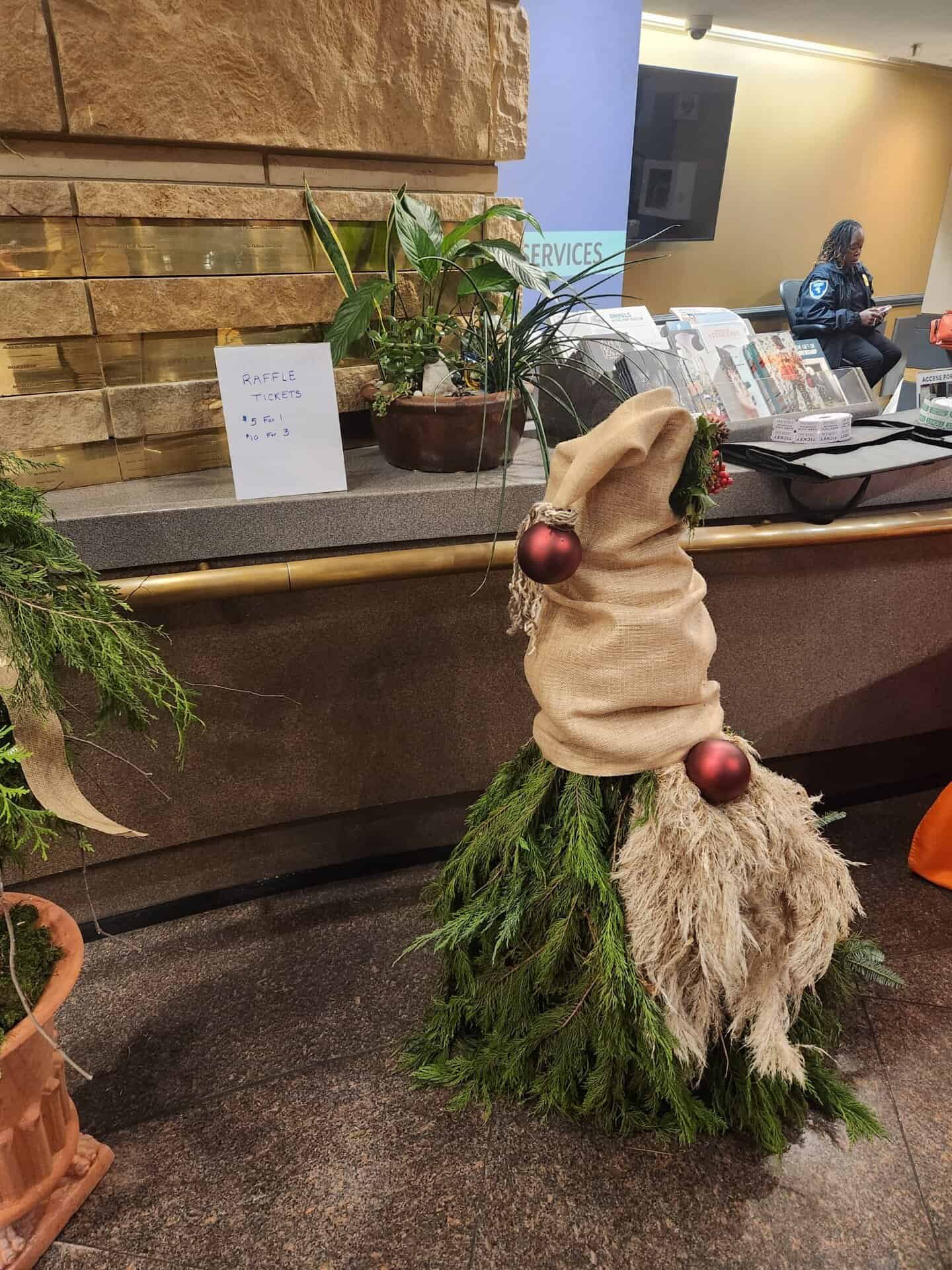 Gnome workshop decoration with a burlap hat and festive ornaments at Charlotte Garden Club event.